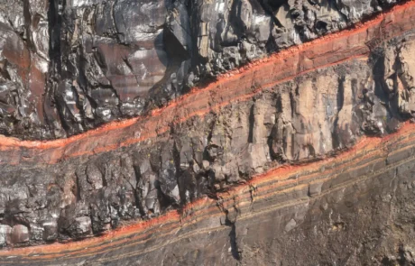 Abstract volcanic rock textures in Iceland showing layers of basalt, minerals and iron-rich formations.
