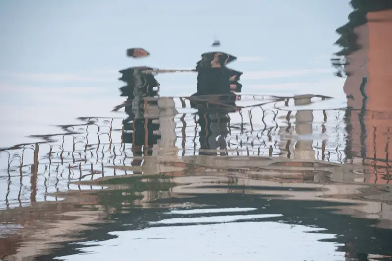Abstract reflections of Venetian Lagoon buildings and waterfront architecture distorted by gentle ripples in the water near Burano.