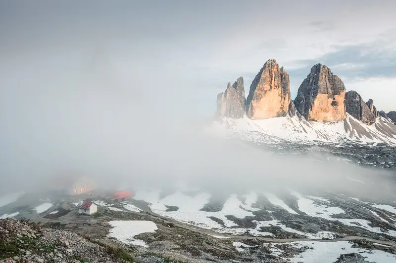 Tre Cime di Lavaredo emerging from the fog in the Italian Dolomites