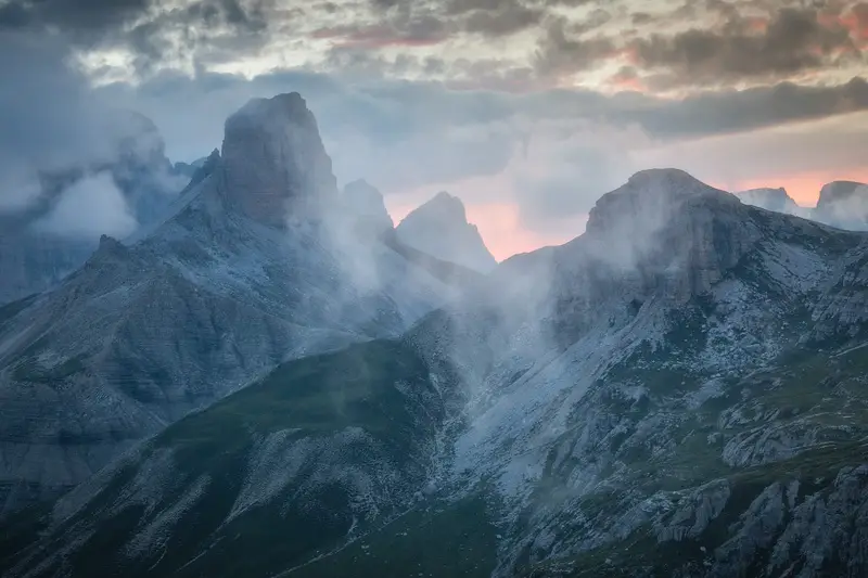 Dolomite peaks surrounded by mist at sunset near Tre Cime di Lavaredo
