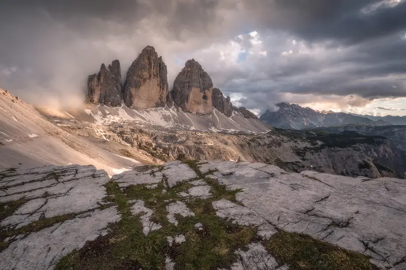 Tre Cime di Lavaredo under dramatic clouds and mountain light in the Dolomites