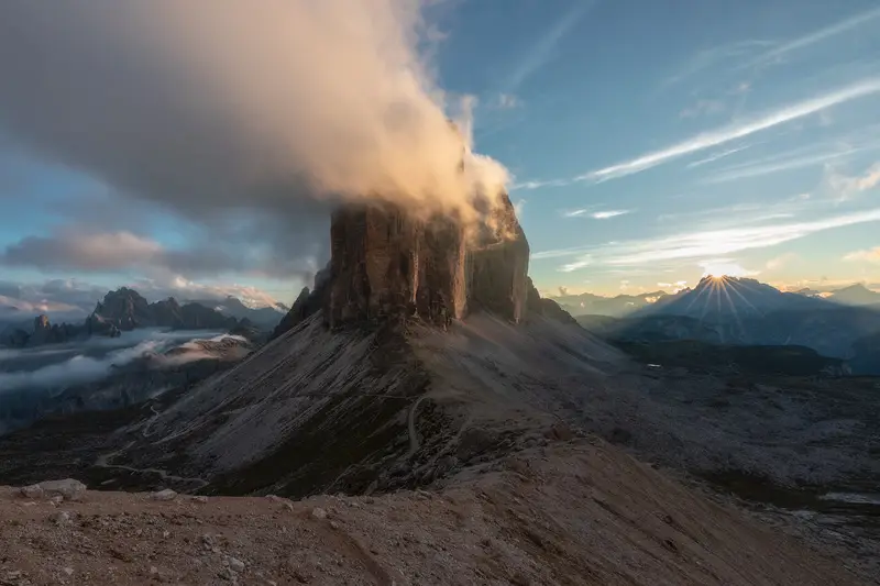 Tre Cime di Lavaredo surrounded by clouds at sunset in the Italian Dolomites
